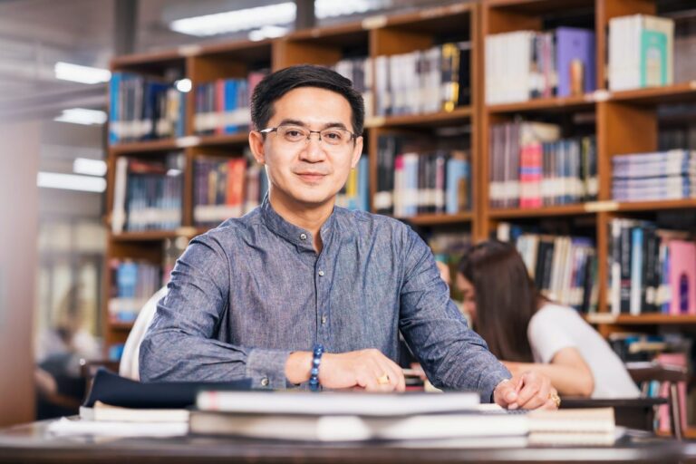 portrait-asian-teacher-sitting-in-the-library-and-classroom-university-education-back-to-school.jpg